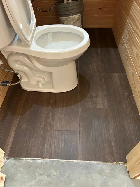 Bathroom floor in the same wood-look tile