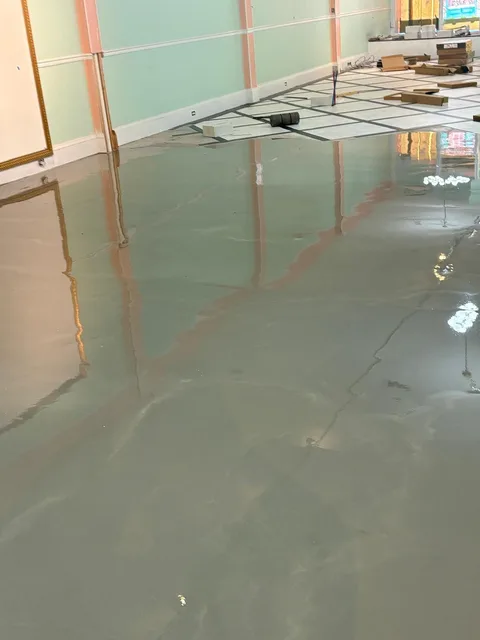 Self-leveling underlayment poured before tile
