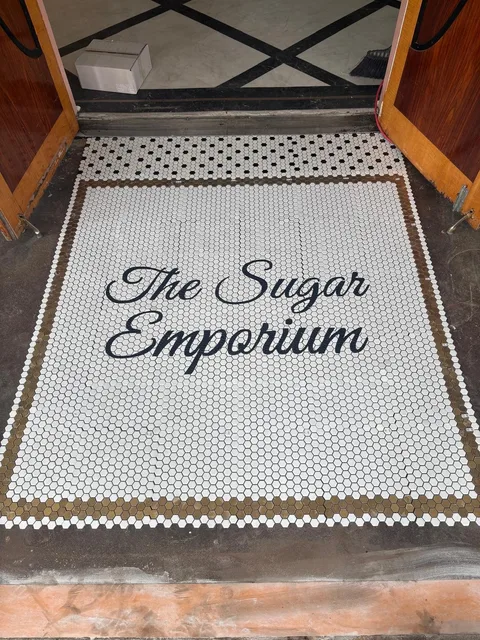 Mosaic logo detail with gold border