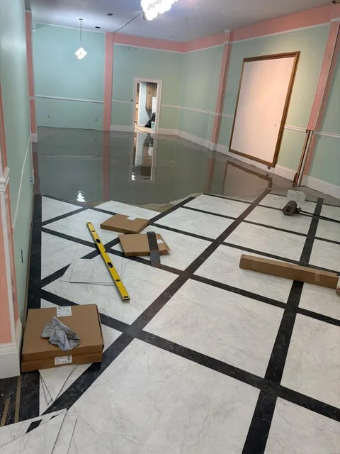 Starting the diagonal marble-and-black-strip layout