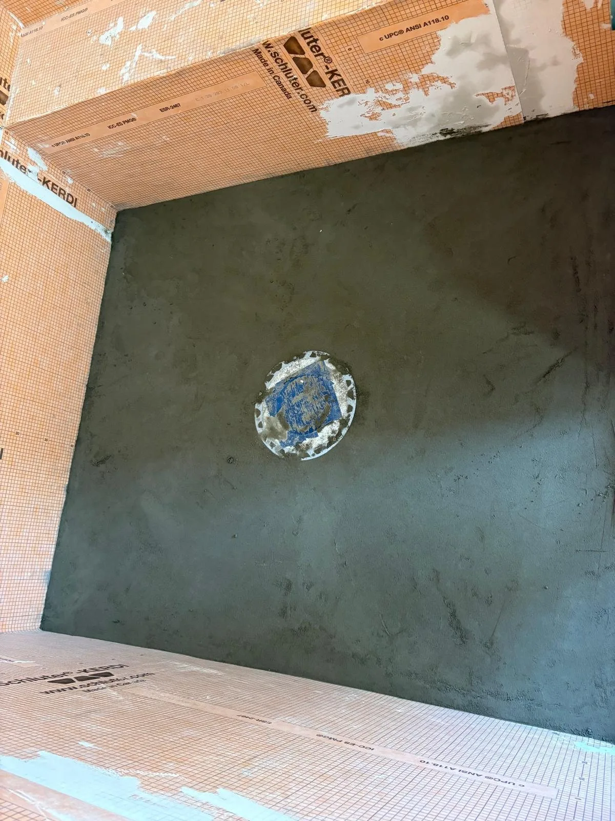Sloped mortar bed toward the drain