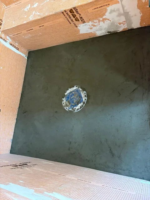Sloped mortar bed toward the drain